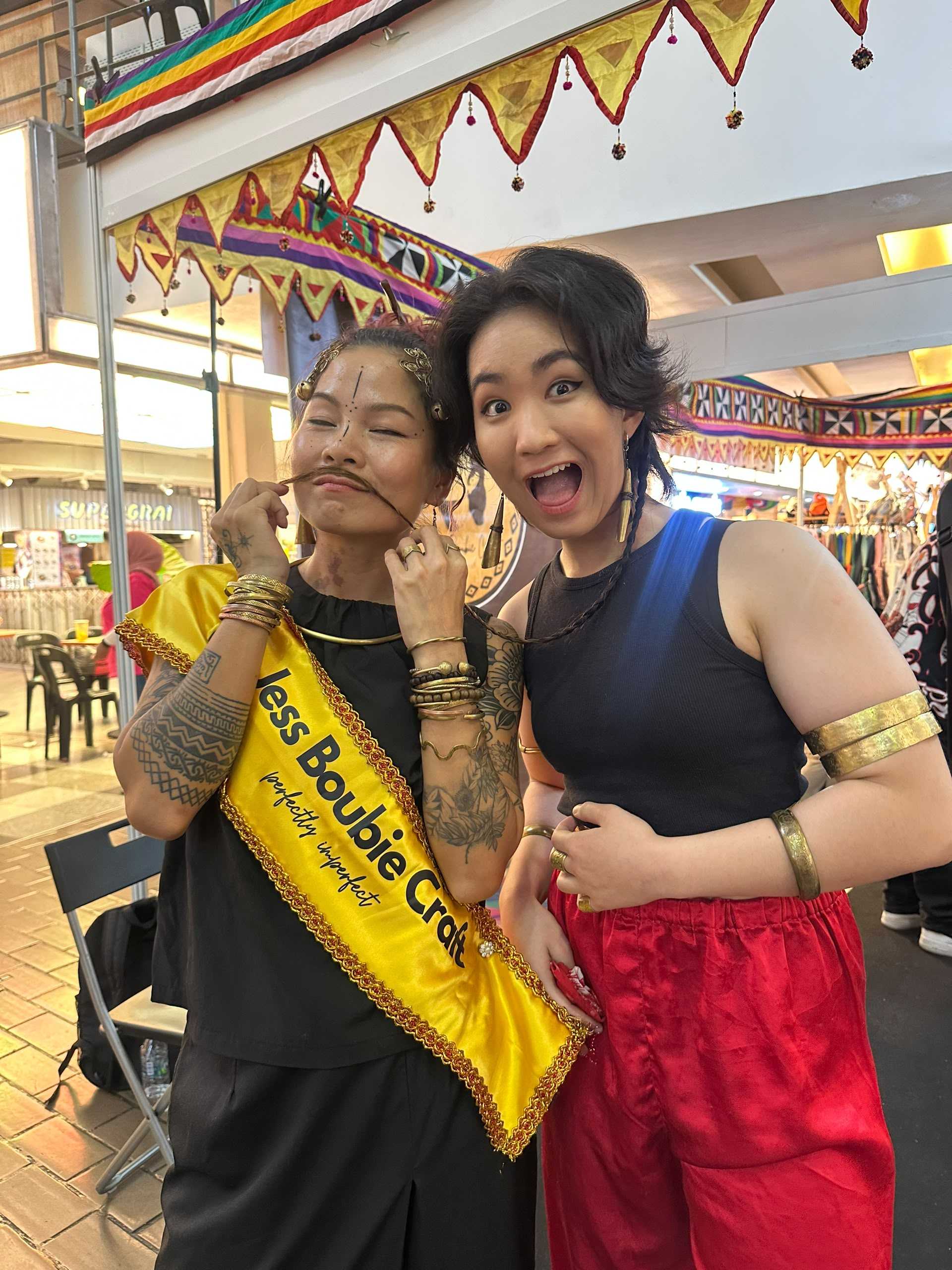 Belle Sisoski and Jess at a market booth, both wearing brass jewelry